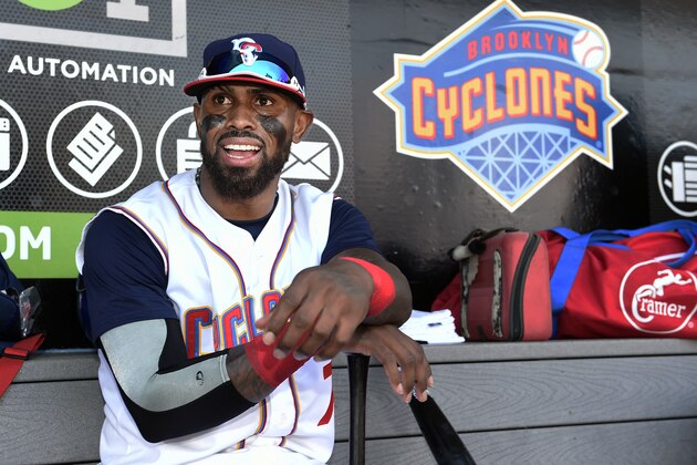 Brooklyn Cyclones Jose Reyes smiles as he rests his hands on his bat in the dugout before a minor league baseball game against the Hudson Valley Renegades, Sunday, June 26, 2016, in New York. Reyes, signed a minor league contract with the New York Mets on Saturday. (AP Photo/Kathy Kmonicek)