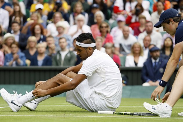 Nick Kyrgios of Australia adjusts his socks during his men's singles match against Andy Murray of Britain on day eight of the Wimbledon Tennis Championships in London, Monday, July 4, 2016. (AP Photo/Kirsty Wigglesworth)