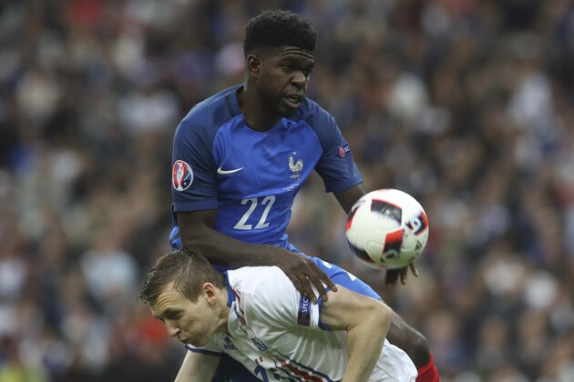 France's Samuel Umtiti, top, challenges for the ball with Iceland's Jon Dadi Bodvarsson during the Euro 2016 quarterfinal soccer match between France and Iceland, at the Stade de France in Saint-Denis, north of Paris, France, Sunday, July 3, 2016. (AP Photo/Petr David Josek)