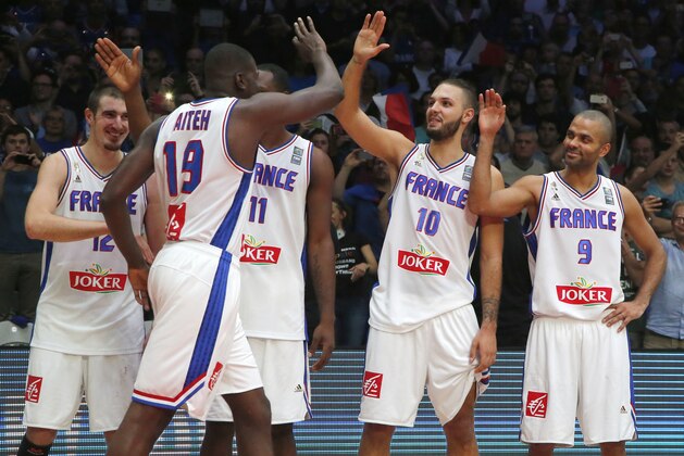 From left, France's Nando De Colo, Mouhammadou Jaiteh, Florent Pietrus, Evan Fournier and Tony Parker, celebrate, after wining the third place final prior to the medal ceremony during the EuroBasket European Basketball Championship bronze medal match, between France against Serbia, at Pierre Mauroy stadium in Lille, northern France, Sunday, Sept. 20, 2015. France won 81-68. (AP Photo/Michel Euler)