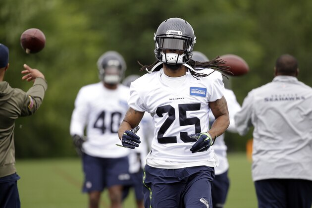 Seattle Seahawks' Richard Sherman runs through a drill at NFL football practice Thursday, May 26, 2016, in Renton, Wash. (AP Photo/Elaine Thompson)