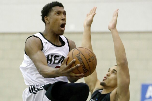 Miami Heat's Josh Richardson, left, drives to the basket over Orlando Magic Blue's Nick Johnson (2) during the first half of an NBA summer league basketball game, Tuesday, July 5, 2016, in Orlando, Fla. (AP Photo/John Raoux)