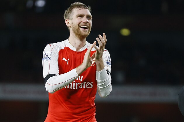 Arsenal's captain Per Mertesacker claps to the fans at the end of the English Premier League soccer match between Arsenal and Bournemouth at Emirates stadium in London, Monday, Dec. 28, 2015. Arsenal won the match 2-0, they now go top of the Premier League table. (AP Photo/Kirsty Wigglesworth)