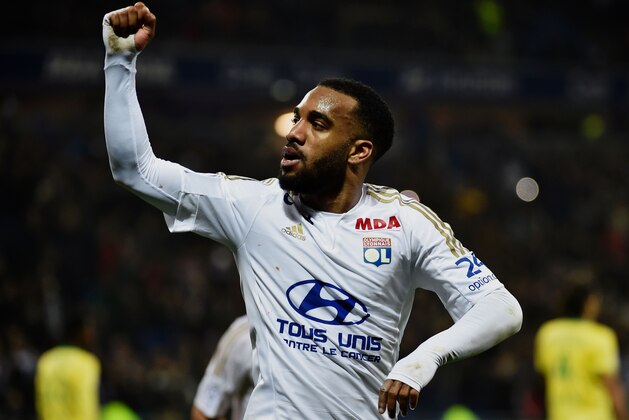 Lyon's French forward Alexandre Lacazette celebrates after scoring a goal during the French L1 football match between Lyon and Nantes at the New Stadium in Decines-Charpieu, central-eastern France, on March 19, 2016. AFP PHOTO / JEFF PACHOUD / AFP / JEFF PACHOUD        (Photo credit should read JEFF PACHOUD/AFP/Getty Images)