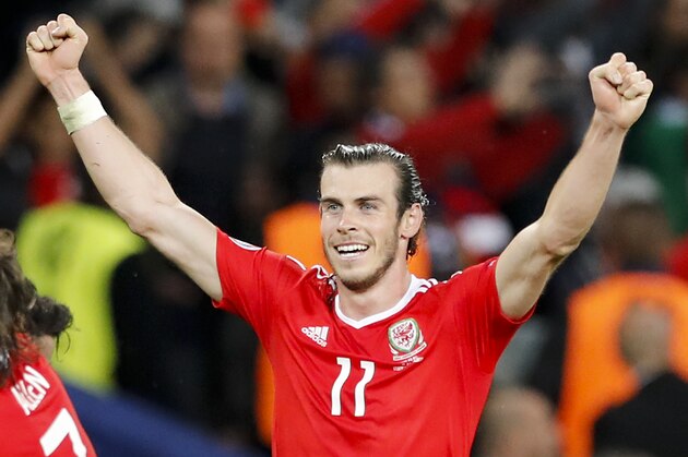 Wales' Gareth Bale celebrates his side's 3-1 win at the end of the Euro 2016 quarterfinal soccer match between Wales and Belgium, at the Pierre Mauroy stadium in Villeneuve d’Ascq, near Lille, France, Friday, July 1, 2016. (AP Photo/ Michel Spingler)