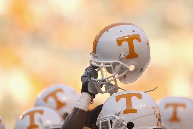 KNOXVILLE, TN - SEPTEMBER 7:  A Tennessee Volunteer holds up his helmet in the team huddle before the NCAA football game against the Middle Tennessee State Blue Raiders at Neyland Stadium on September 7, 2002 in Knoxville, Tennessee. Tennessee won 26-3. (Photo by Elsa/Getty Images)