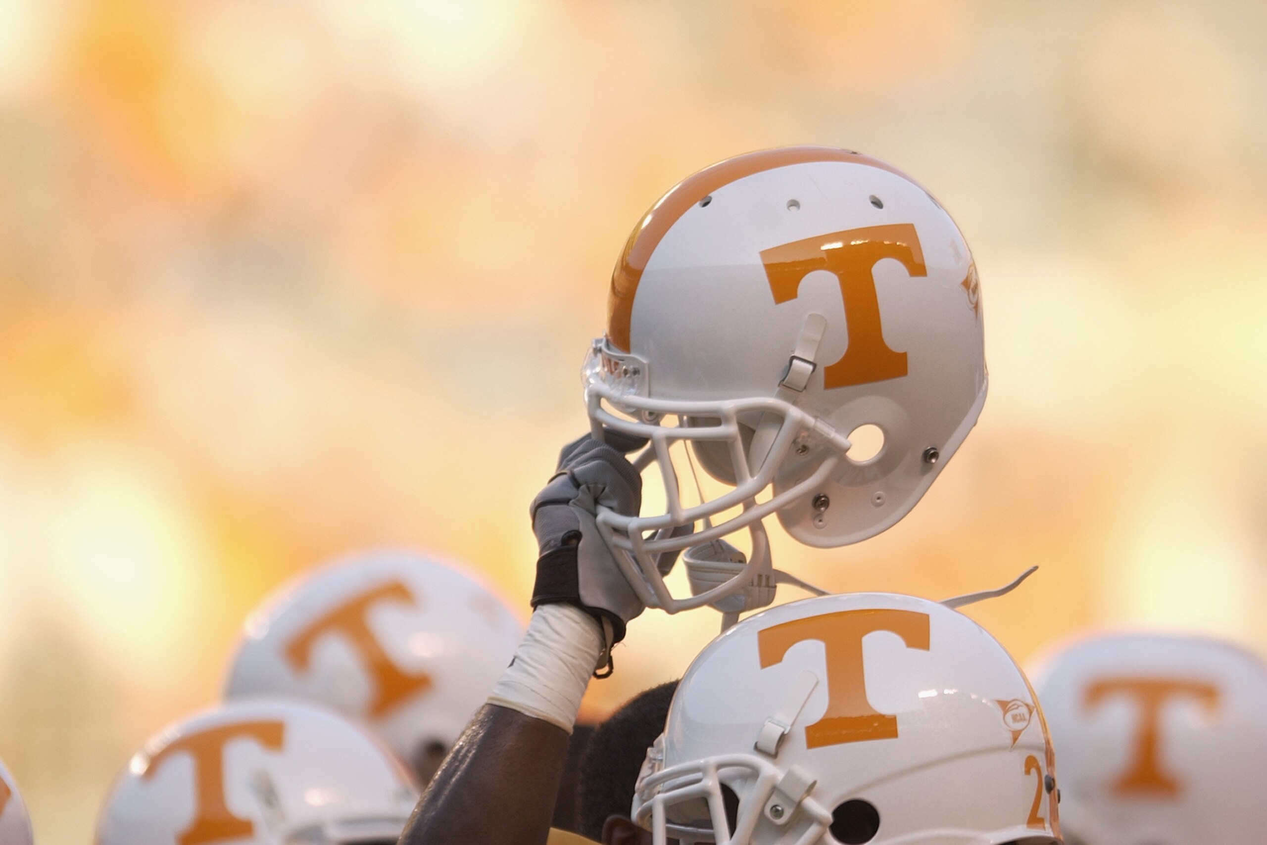 KNOXVILLE, TN - SEPTEMBER 7:  A Tennessee Volunteer holds up his helmet in the team huddle before the NCAA football game against the Middle Tennessee State Blue Raiders at Neyland Stadium on September 7, 2002 in Knoxville, Tennessee. Tennessee won 26-3. (Photo by Elsa/Getty Images)
