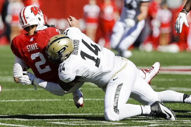 Purdue defensive tackle Ra'Zahn Howard (14) sacks Wisconsin quarterback Joel Stave (2) during the first half of an NCAA college football game Saturday, Oct. 17, 2015, in Madison, Wis. (AP Photo/Andy Manis)