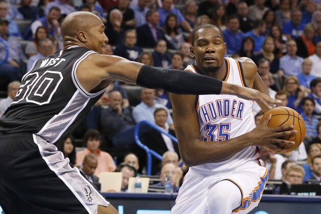 San Antonio Spurs forward David West (30) defends as Oklahoma City Thunder forward Kevin Durant (35) drives to the basket in the second quarter of an NBA basketball game in Oklahoma City, Wednesday, Oct. 28, 2015. (AP Photo/Sue Ogrocki)