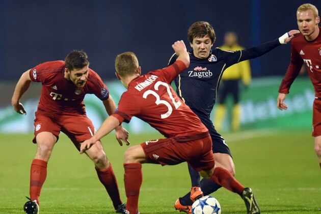 Dinamo Zagreb's midfielder Ante Coric (R) vies with Bayern Munich's Spanish midfielder Xabi Alonso and Bayern Munich's midfielder Joshua Kimmich (C) during the UEFA Champions League football match between Dinamo Zagreb v Bayern Munich at the Maksimir stadium in Zagreb on December 9, 2015. AFP PHOTO / DENIS LOVROVIC / AFP / DENIS LOVROVIC        (Photo credit should read DENIS LOVROVIC/AFP/Getty Images)