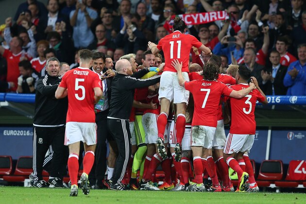 LILLE, FRANCE - JULY 01: Hal Robson-Kanu of Wales is mobbed by his team-mates after scoring his side's second goal during the UEFA Euro 2016 Quarter Final match between Wales and Belgium at Stade Pierre-Mauroy on July 1, 2016 in Lille, France. (Photo by Chris Brunskill Ltd/Getty Images)