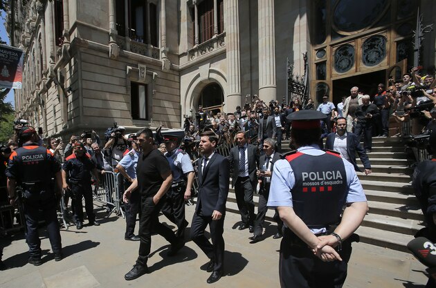 Barcelona soccer player Lionel Messi, center, leaves the court in Barcelona, Spain, Thursday, June 2, 2016. Lionel Messi denied having knowledge of the tax issues that led to fraud charges against him, saying Thursday he signed documents without reading them because he trusted his father and the advisers responsible for managing his finances. “I didn’t know anything,” Messi said while testifying in his tax fraud trial. “I only worried about playing football.” (AP Photo/Manu Fernandez)