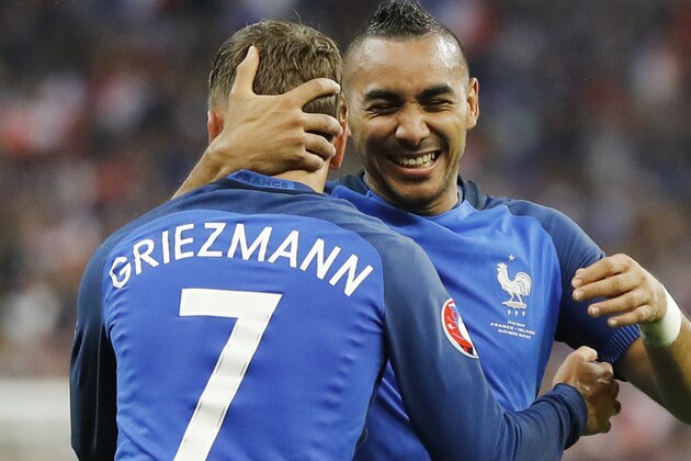 France's Dimitri Payet, right, congratulates his teammate Antoine Griezmann after scoring their fourth goal during the Euro 2016 quarterfinal soccer match between France and Iceland, at the Stade de France in Saint-Denis, north of Paris, France, Sunday, July 3, 2016. (AP Photo/Frank Augstein)