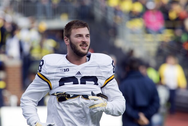 Michigan tight end Jake Butt runs on the field during warmups before the NCAA college football team's annual Spring Game at Michigan Stadium in Ann Arbor, Mich., Friday, April 1, 2016. (AP Photo/Tony Ding)