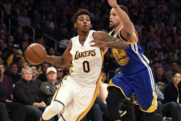 Mar 6, 2016; Los Angeles, CA, USA; Los Angeles Lakers forward Nick Young (0) drives to the basket against Golden State Warriors guard Stephen Curry (30) during the NBA game at the Staples Center. Mandatory Credit: Richard Mackson-USA TODAY Sports