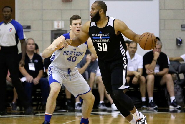 Orlando Magic White's Arinze Onuaku (50) moves the ball to get around New York Knicks' Marshall Plumlee (40) during the first half of an NBA summer league basketball game, Wednesday, July 6, 2016, in Orlando, Fla. (AP Photo/John Raoux)