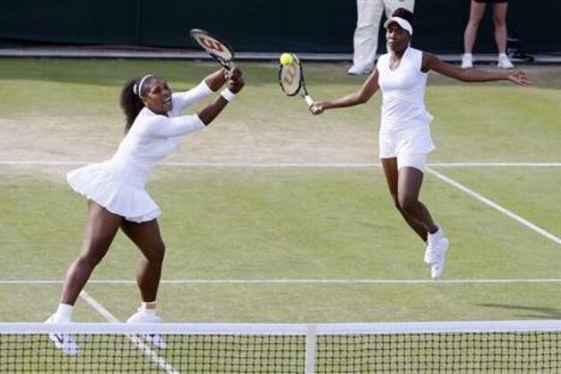 CORRECTS PLAYERS' POSITION AND MATCH - Venus Williams, right, and Serena Williams of the U.S return to Andrea Hlavackova and Lucie Hradecka during their women's doubles match on day nine of the Wimbledon Tennis Championships in London, Tuesday, July 5, 2016. (AP Photo/Kirsty Wigglesworth)