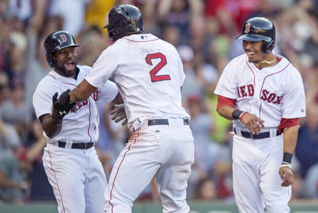BOSTON, MA - SEPTEMBER 5: Xander Bogaerts #2 of the Boston Red Sox celebrates with Jackie Bradley Jr. #25 and Mookie Betts #50  after hitting a bases clearing triple and then scoring on a throwing error during the fourth inning against the Philadelphia Phillies at Fenway Park on September 5, 2015 in Boston, Massachusetts. (Photo by Michael Ivins/Boston Red Sox/Getty Images)
