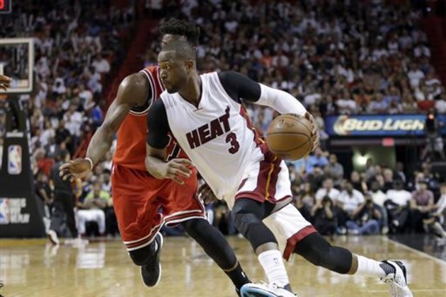 FILE - In this April 7, 2016, file photo, Miami Heat guard Dwyane Wade (3) drives around Chicago Bulls guard Jimmy Butler during an NBA basketball game in Miami. A person with knowledge of the situation tells The Associated Press that Wade has decided to leave the Heat and sign with the Bulls. Wade made the decision Wednesday night, July 6, according to the person who spoke on condition of anonymity because nothing can be finalized before Thursday. (AP Photo/Alan Diaz, File)