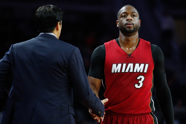 Apr 12, 2016; Auburn Hills, MI, USA; Miami Heat guard Dwyane Wade (3) comes to the bench and shakes hands with head coach Erik Spoelstra during the first quarter against the Detroit Pistons at The Palace of Auburn Hills. Heat win 99-93. Mandatory Credit: Raj Mehta-USA TODAY Sports