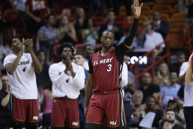 Miami Heat guard Dwyane Wade (3) waves to the crowd after being acknowledged for scoring 20,000 career points during the second half of an NBA basketball game against the Cleveland Cavaliers, Saturday, March 19, 2016, in Miami. (AP Photo/Lynne Sladky)