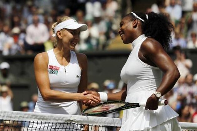 Serena Williams of the U.S, right, shakes hands with Elena Vesnina of Russia after beating her in their women's singles match n day ten of the Wimbledon Tennis Championships in London, Thursday, July 7, 2016. (AP Photo/Ben Curtis, pool)