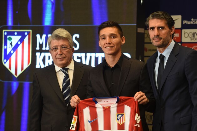 New Atletico de Madrid's Argentinian midfielder Matias Kranevitter (C) poses with his new jersey and Atletico de Madrid's president Enrique Cerezo (L) and Atletico de Madrid sport manager Jose Luis Perez Caminero during his presentation at the Vicente Calderon stadium in Madrid, on January 4, 2016.  / AFP / PEDRO ARMESTRE        (Photo credit should read PEDRO ARMESTRE/AFP/Getty Images)