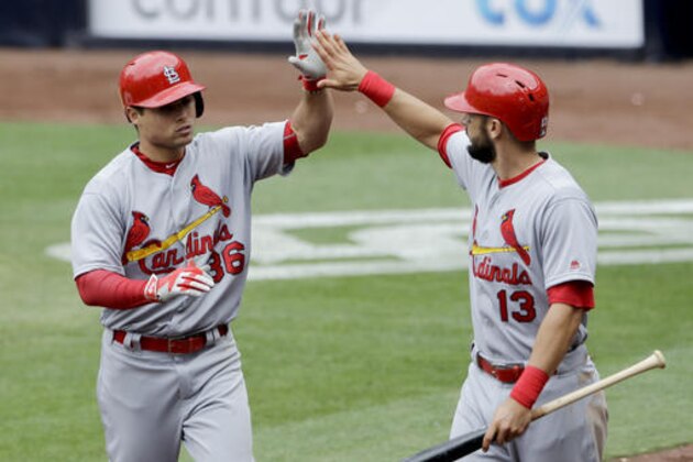 St. Louis Cardinals' Aledmys Diaz, left is greeted by teammate Matt Carpenter (13) after hitting a home run during the sixth inning of a baseball game against the San Diego Padres Sunday, April 24, 2016, in San Diego. (AP Photo/Gregory Bull)