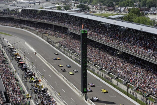 The field heads into the first turn on the start of the 100th running of the Indianapolis 500 auto race at Indianapolis Motor Speedway in Indianapolis, Sunday, May 29, 2016. (AP Photo/Michael Conroy)
