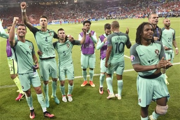 Portugal's Cristiano Ronaldo, left, and his teammates celebrate at the end of the Euro 2016 semifinal soccer match between Portugal and Wales, at the Grand Stade in Decines-­Charpieu, near Lyon, France, Wednesday, July 6, 2016. Portugal won 2-0. (AP Photo/Martin Meissner)