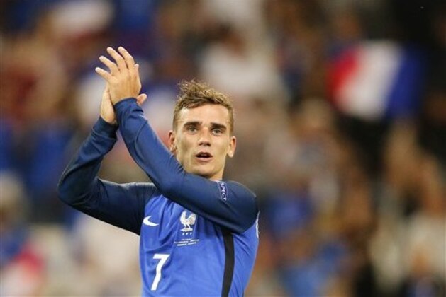 France's Antoine Griezmann acknowledges the supporter after his team won 2-0 during the Euro 2016 semifinal soccer match between Germany and France, at the Velodrome stadium in Marseille, France, Thursday, July 7, 2016. (AP Photo/Michael Probst)