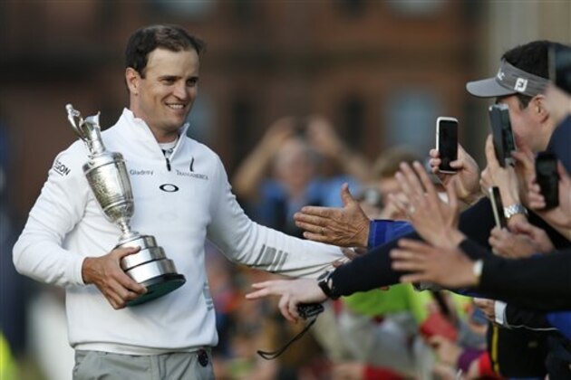 United States’ Zach Johnson celebrates with members of the public as he holds the trophy after winning a playoff after the final round at the British Open Golf Championship at the Old Course, St. Andrews, Scotland, Monday, July 20, 2015.(AP Photo/Jon Super) United States’ Zach Johnson celebrates with members of the public as he holds the trophy after winning a playoff after the final round at the British Open Golf Championship at the Old Course, St. Andrews, Scotland, Monday, July 20, 2015.(AP Photo/Jon Super)