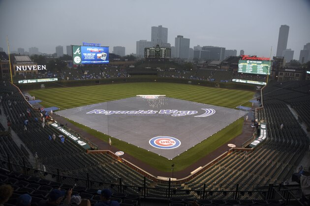 CHICAGO, IL - JULY 7: The field is covered by a tarp as rain falls before a game between the Chicago Cubs and the Atlanta Braves on July 7, 2016 at Wrigley Field in Chicago, Illinois. (Photo by David Banks/Getty Images)