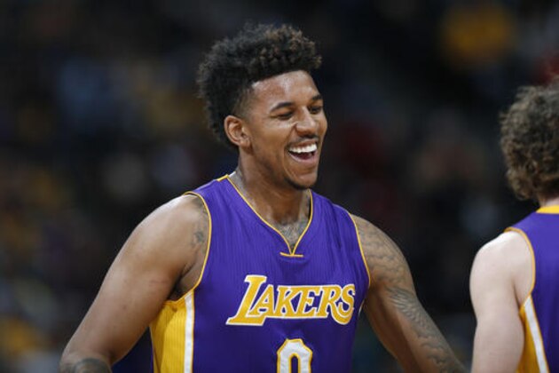 Los Angeles Lakers forward Nick Young smiles after hitting a 3-point basket against the Denver Nuggets during the second half of an NBA basketball game Wednesday, March 2, 2016, in Denver. The Nuggets won 117-107. (AP Photo/David Zalubowski)