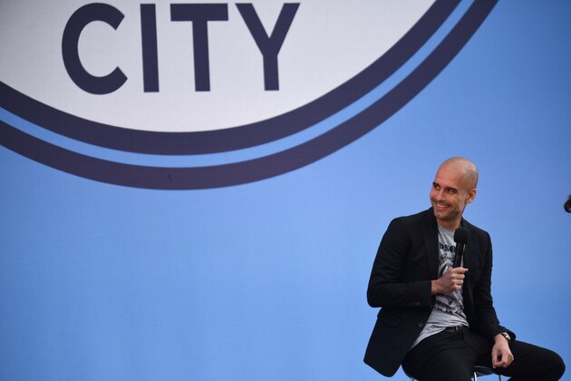 TOPSHOT - Spanish football manager Pep Guardiola speaks to Manchester City fans as he is officially unveiled as the club's new manager at the City Football Academy in Manchester, north west England on July 3, 2016. / AFP / OLI SCARFF        (Photo credit should read OLI SCARFF/AFP/Getty Images)
