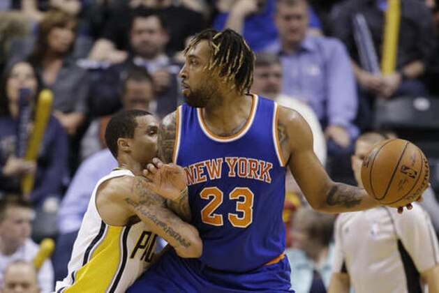 New York Knicks' Derrick Williams (23) is defended by Indiana Pacers' George Hill (3) during the second half of an NBA basketball game Tuesday, April 12, 2016, in Indianapolis. Indiana won 102-90. (AP Photo/Darron Cummings)
