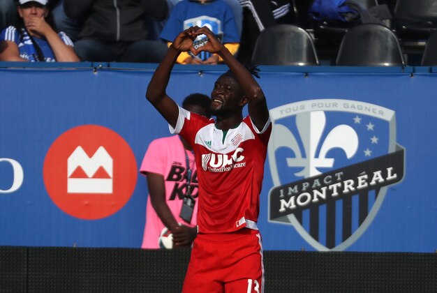 Jul 2, 2016; Montreal, Quebec, CAN; New England Revolution forward Kei Kamara (13) cheers as he scored a goal against Montreal Impact during the first half at Stade Saputo. Mandatory Credit: Jean-Yves Ahern-USA TODAY Sports