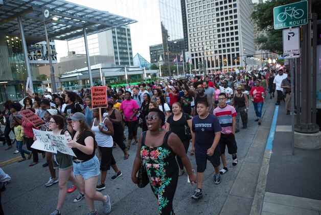People rally in Dallas, Texas, on Thursday, July 7, 2016 to protest the deaths of Alton Sterling and Philando Castile.
Black motorist Philando Castile, 32, a school cafeteria worker, was shot at close range by a Minnesota cop and seen bleeding to death in a graphic video shot by his girlfriend that went viral Thursday, the second fatal police shooting to rock America in as many days. / AFP / Laura Buckman        (Photo credit should read LAURA BUCKMAN/AFP/Getty Images)