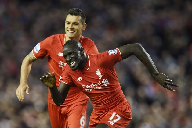 Liverpool's French defender Mamadou Sakho (R) celebrates with Liverpool's Croatian defender Dejan Lovren after scoring during the English Premier League football match between Liverpool and Everton at Anfield in Liverpool, north west England on April 20, 2016. / AFP / PAUL ELLIS / RESTRICTED TO EDITORIAL USE. No use with unauthorized audio, video, data, fixture lists, club/league logos or 'live' services. Online in-match use limited to 75 images, no video emulation. No use in betting, games or single club/league/player publications.  /         (Photo credit should read PAUL ELLIS/AFP/Getty Images)