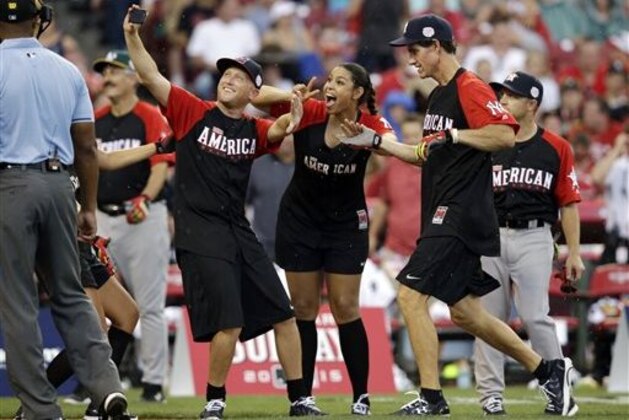 Paul O’Neill celebrates with his teammates after hitting a home run during the All-Star Legends & Celebrity Softball game, Sunday, July 12, 2015, in Cincinnati. (AP Photo/John Minchillo)