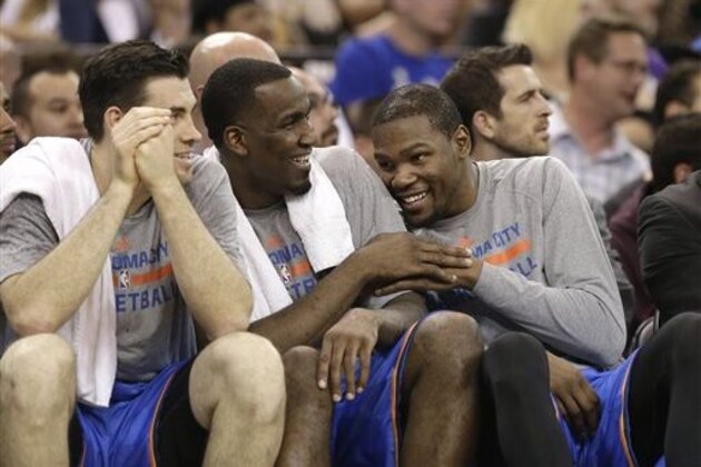Oklahoma City Thunder Nick Collison, left, Kendrick Perkins, center and Kevin Durant relax on the bench during the closing moments of the Thunders 107-92 win over the Sacramento Kings  in a NBA basketball game, Tuesday, April 8, 2014, in Sacramento, Calif.(AP Photo/Rich Pedroncelli)