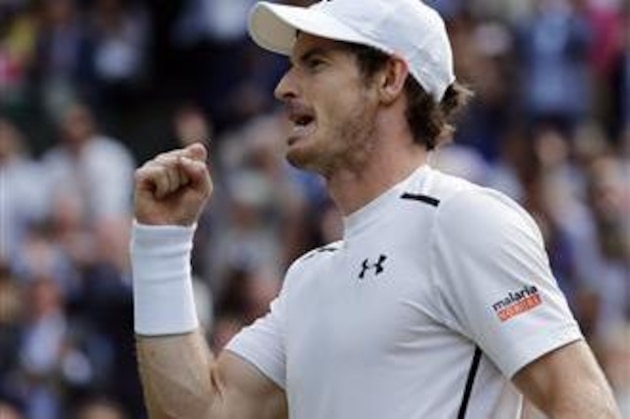Andy Murray of Britain celebrates after beating Tomas Berdych of the Czech Republic in their men's semifinal singles match on day twelve of the Wimbledon Tennis Championships in London, Friday, July 8, 2016. (AP Photo/Ben Curtis)