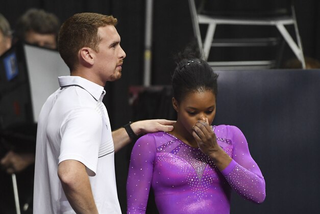 July 8, 2016; San Jose, CA, USA; Gabby Douglas (right), from Tarzana, CA, reacts with coach Christian Gallardo (left) after the balance beam in the women's gymnastics U.S. Olympic team trials at SAP Center. Mandatory Credit: Kyle Terada-USA TODAY Sports