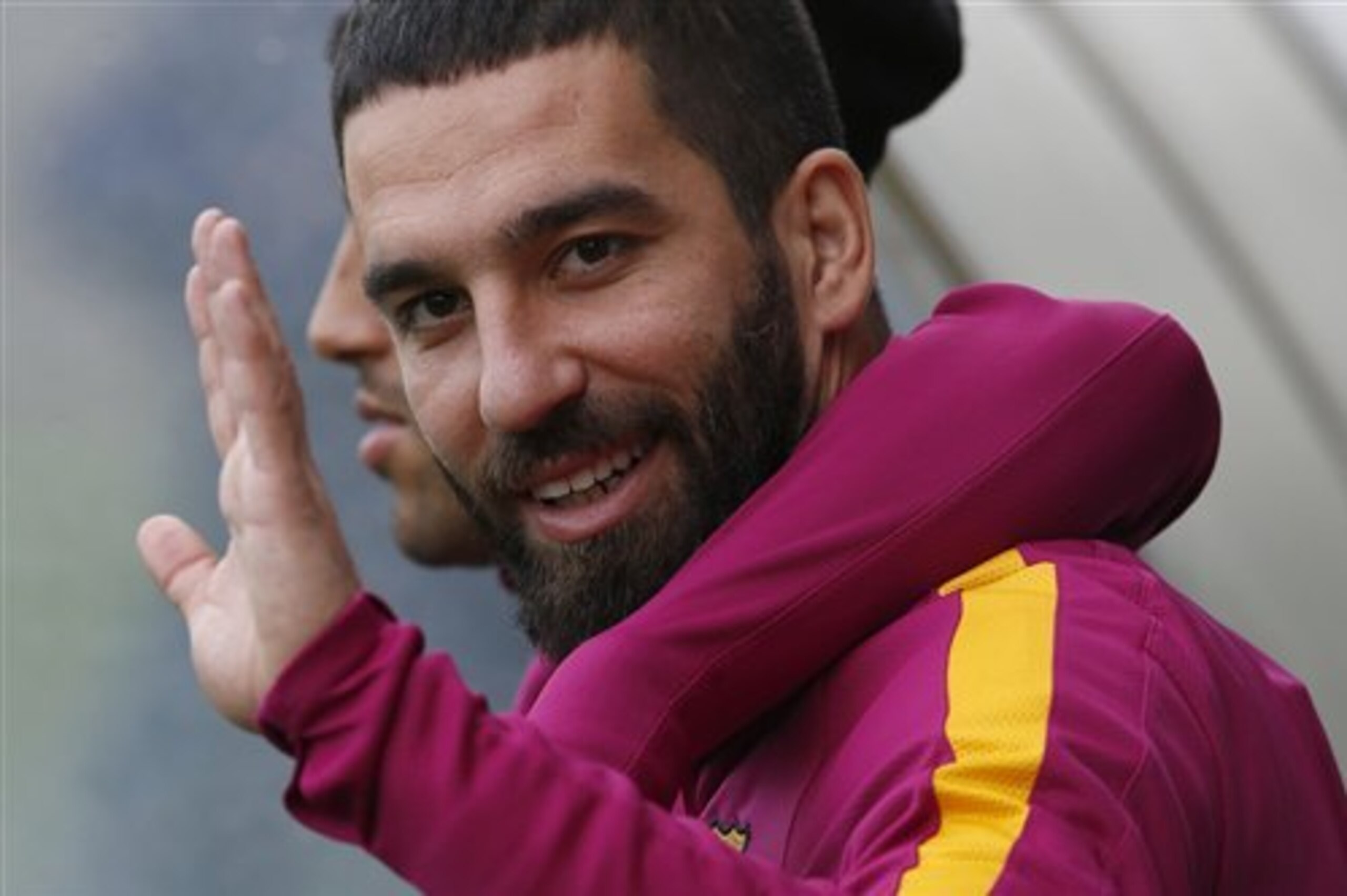 FC Barcelona's Arda Turan waves to the media during a training session at the Sports Center FC Barcelona Joan Gamper in San Joan Despi, Spain, Friday, April 1, 2016. FC Barcelona will play against Real Madrid Saturday in a Spanish La Liga soccer match, dubbed 'el clasico'. (AP Photo/Manu Fernandez)