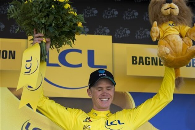 Britain's Chris Froome, wearing the overall leader's yellow jersey, celebrates on the podium of the eighth stage of the Tour de France cycling race over 184 kilometers (114.3 miles) with start in Pau and finish in Bagneres-de-Luchon, France, Saturday, July 9, 2016. (AP Photo/Peter Dejong)