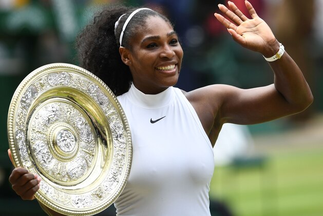 US player Serena Williams poses with the winner's trophy, the Venus Rosewater Dish, after her women's singles final victory over Germany's Angelique Kerber on the thirteenth day of the 2016 Wimbledon Championships at The All England Lawn Tennis Club in Wimbledon, southwest London, on July 9, 2016. / AFP / GLYN KIRK / RESTRICTED TO EDITORIAL USE        (Photo credit should read GLYN KIRK/AFP/Getty Images)