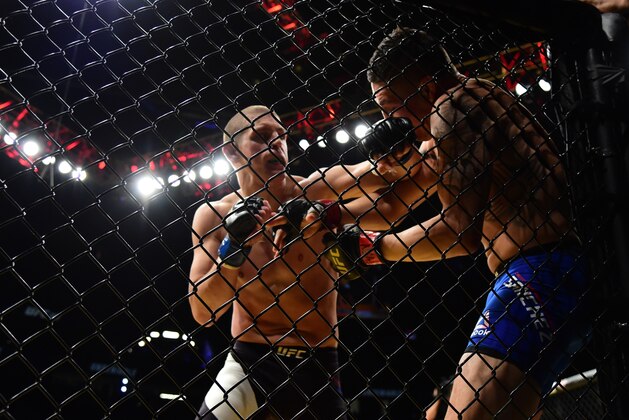 LAS VEGAS, NV - JULY 09: (L-R) Joe Lauzon punches Diego Sanchez in their lightweight bout during the UFC 200 event on July 9, 2016 at T-Mobile Arena in Las Vegas, Nevada.  (Photo by Harry How/Zuffa LLC/Zuffa LLC via Getty Images)