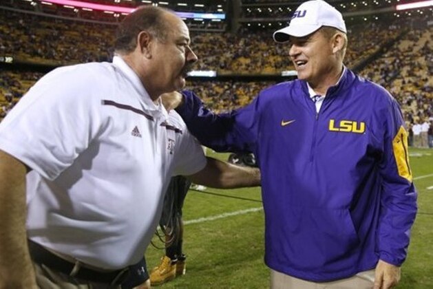 LSU head coach Les Miles greets Texas A&M defensive coordinator John Chavis before an NCAA college football game in Baton Rouge, La., Saturday, Nov. 28, 2015. (AP Photo/Jonathan Bachman)