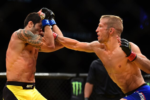 LAS VEGAS, NV - JULY 09: (R-L) TJ Dillashaw punches Raphael Assuncao of Brazil in their bantamweight bout during the UFC 200 event on July 9, 2016 at T-Mobile Arena in Las Vegas, Nevada.  (Photo by Harry How/Zuffa LLC/Zuffa LLC via Getty Images)