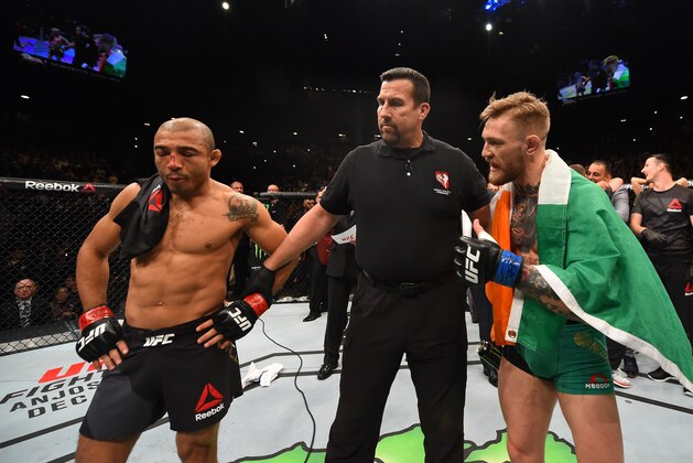 LAS VEGAS, NV - DECEMBER 12: Jose Aldo of Brazil (left) and Conor McGregor of Ireland (right) await the final decision in their UFC featherweight championship bout during the UFC 194 event inside MGM Grand Garden Arena on December 12, 2015 in Las Vegas, Nevada.  (Photo by Josh Hedges/Zuffa LLC/Zuffa LLC via Getty Images)